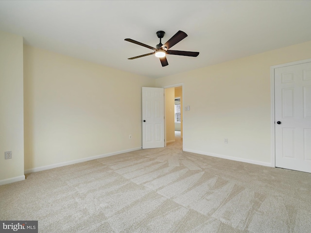 carpeted empty room featuring ceiling fan