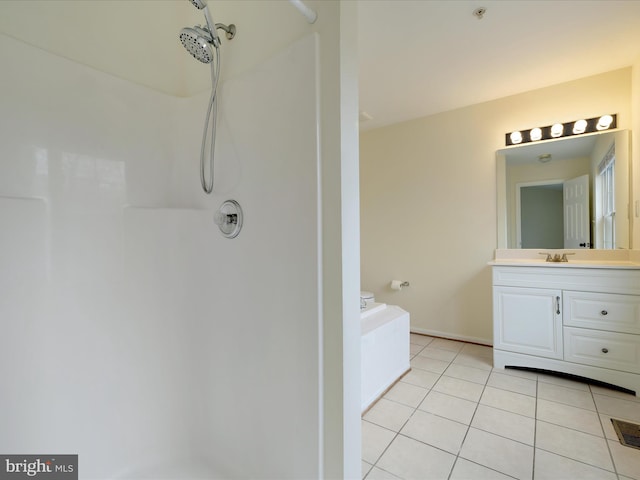 bathroom featuring vanity, a shower, and tile patterned floors