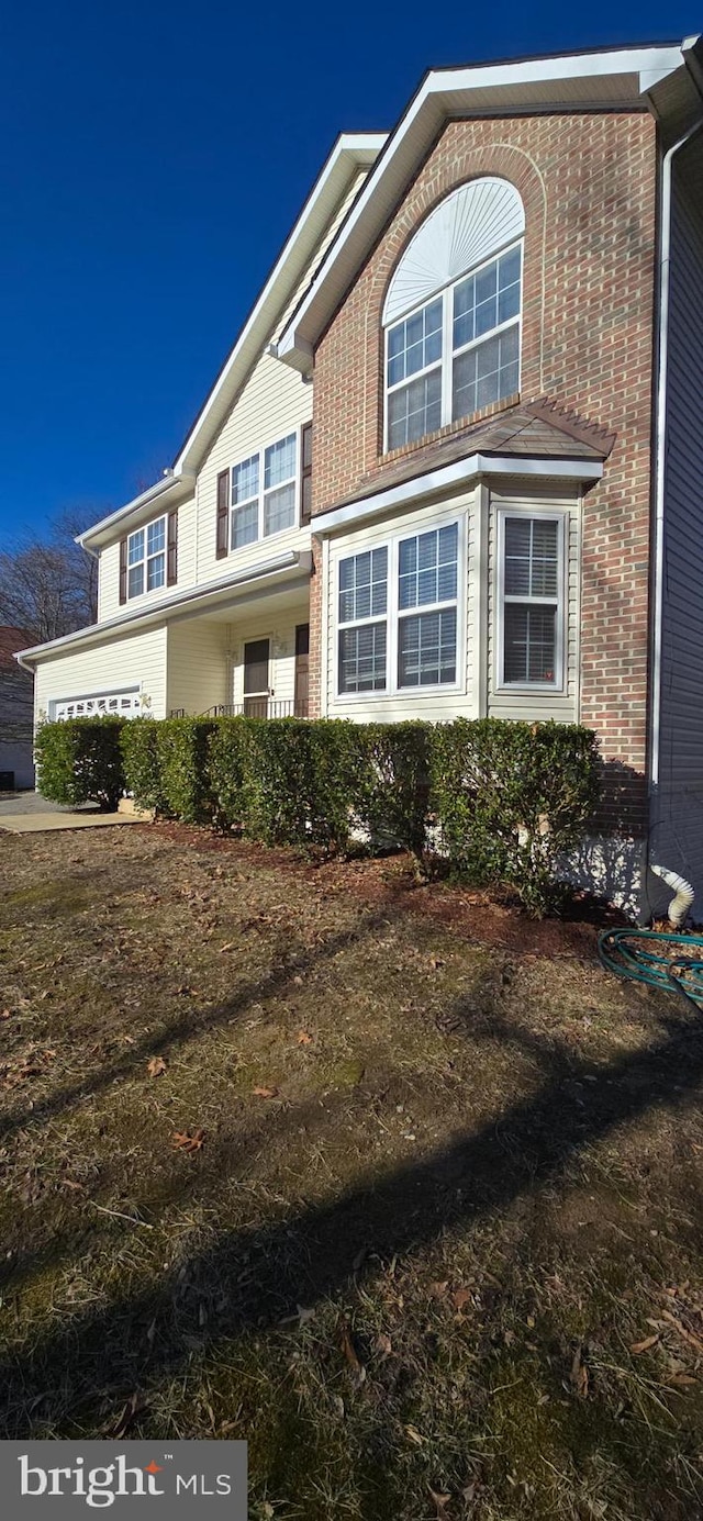 view of front of house with a garage and a front lawn