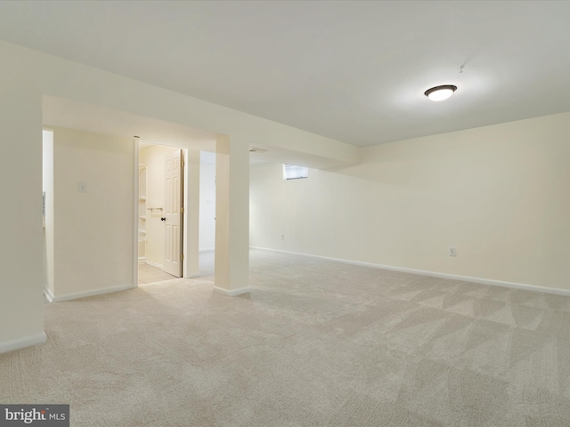 basement featuring light carpet