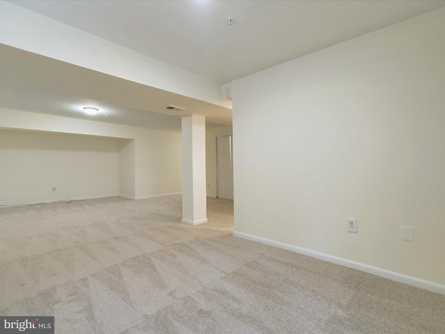 basement featuring light colored carpet