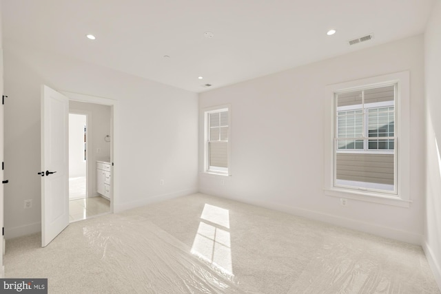 unfurnished bedroom with baseboards, recessed lighting, visible vents, and light colored carpet