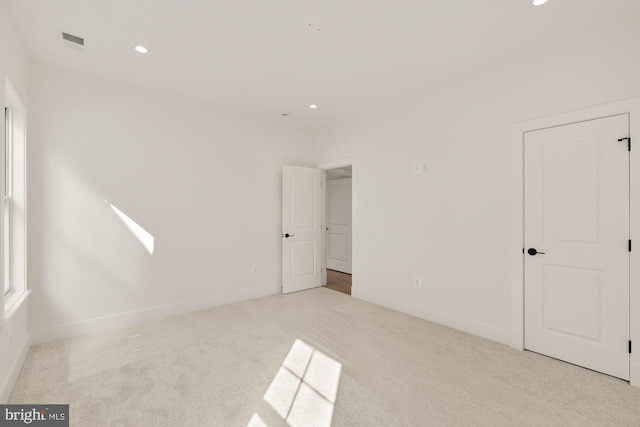 unfurnished bedroom with recessed lighting, visible vents, and carpet flooring