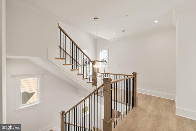 stairway featuring baseboards, wood finished floors, and recessed lighting