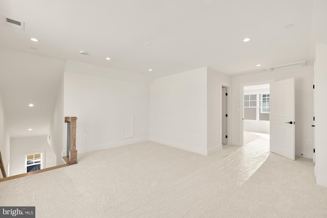 unfurnished room with light carpet, baseboards, visible vents, and recessed lighting