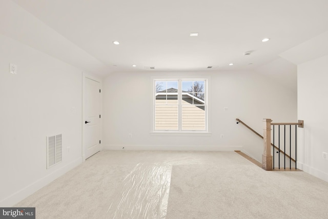 unfurnished room with lofted ceiling, visible vents, and recessed lighting