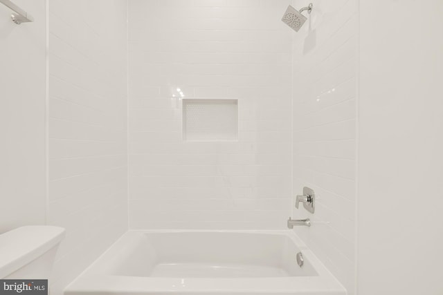 bathroom featuring toilet and bathing tub / shower combination