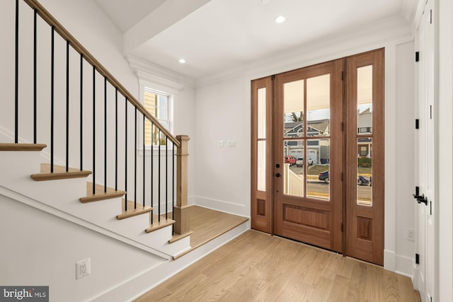 entrance foyer with ornamental molding, recessed lighting, baseboards, and wood finished floors