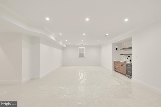 interior space with wine cooler, wet bar, baseboards, and recessed lighting