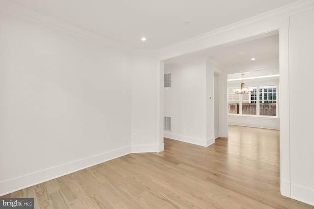 unfurnished room featuring a chandelier, visible vents, and ornamental molding