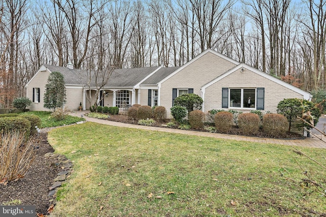 ranch-style home with brick siding and a front yard