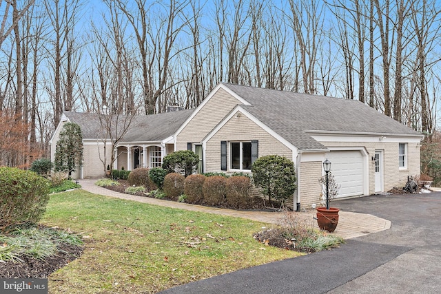 view of front of home with a garage and a front yard