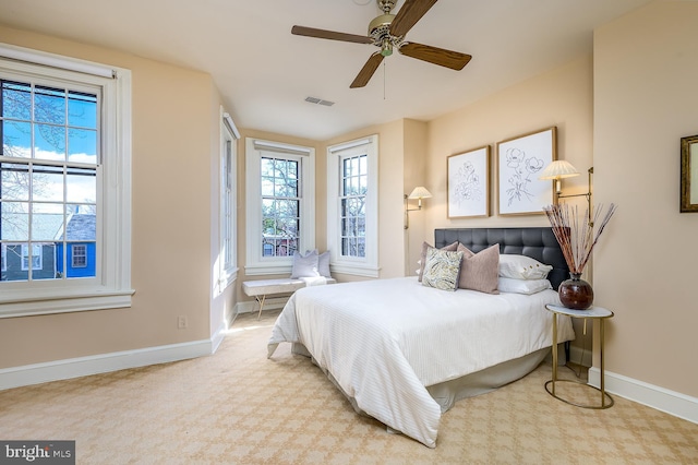 bedroom featuring light colored carpet and ceiling fan