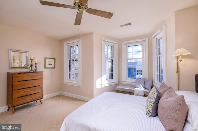 bedroom featuring light carpet and ceiling fan