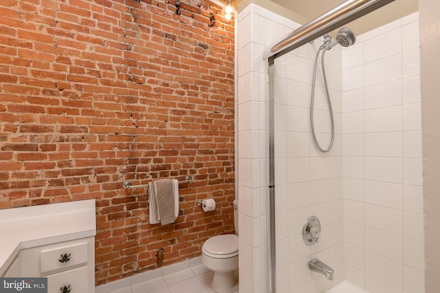 bathroom featuring tile patterned flooring, combined bath / shower with glass door, toilet, and brick wall