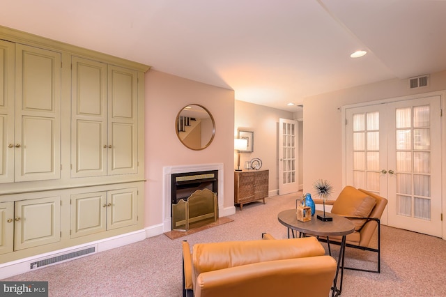 living room with french doors and light colored carpet