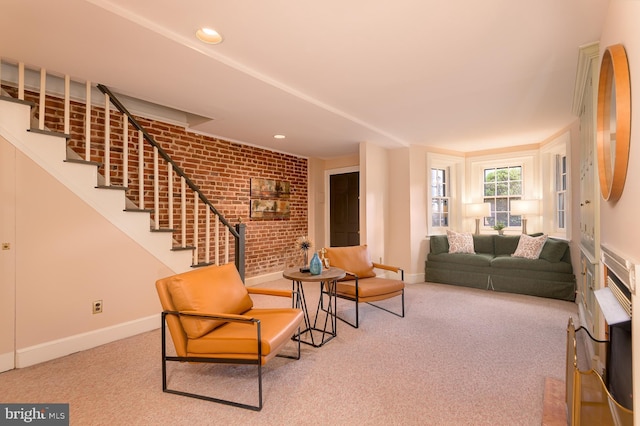 carpeted living room with brick wall