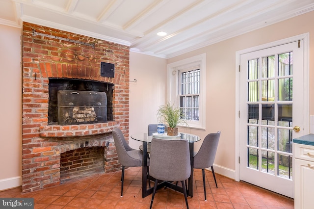 tiled dining space featuring crown molding, a wealth of natural light, and a fireplace