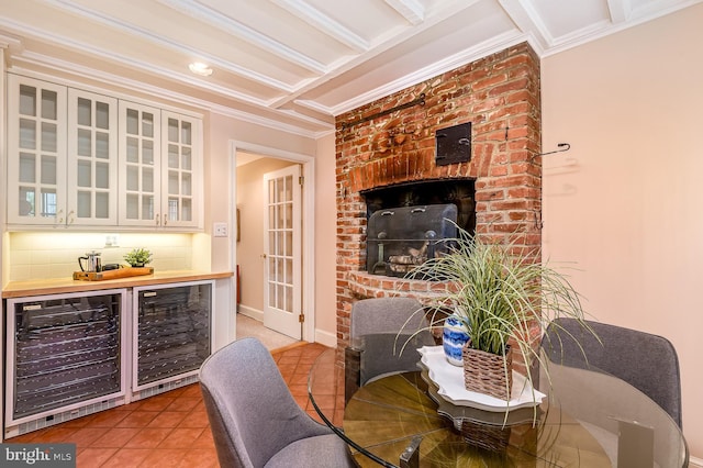 tiled dining room featuring beamed ceiling, crown molding, indoor bar, and wine cooler