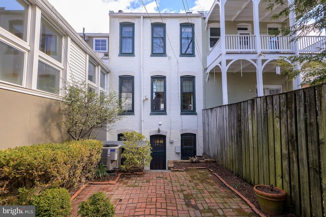 entrance to property featuring cooling unit and a patio