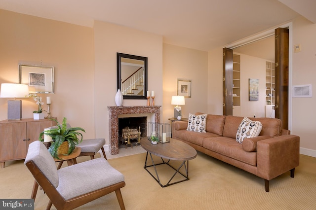 living room featuring light carpet and a fireplace