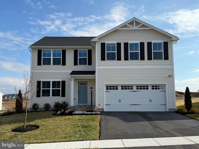 view of front of property with a garage and a front lawn