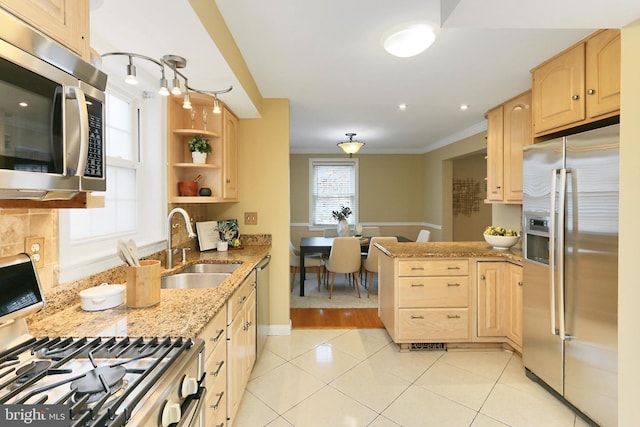 kitchen with appliances with stainless steel finishes, sink, light tile patterned floors, crown molding, and light brown cabinets