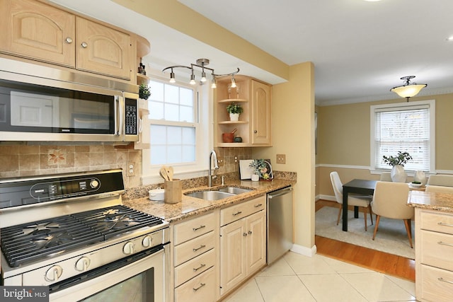 kitchen with appliances with stainless steel finishes, sink, decorative backsplash, ornamental molding, and light brown cabinets