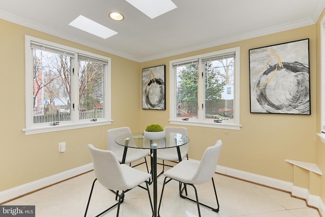 dining room with light tile patterned flooring, ornamental molding, and a skylight