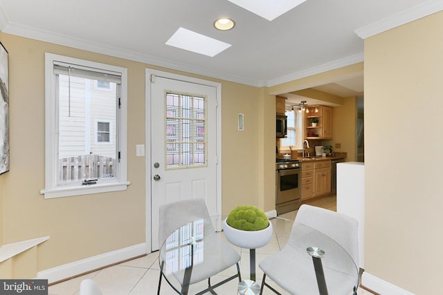 doorway to outside featuring crown molding, sink, light tile patterned floors, and a skylight