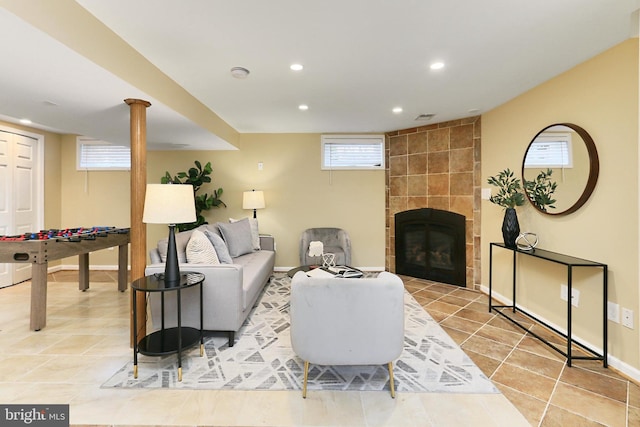 living room featuring light tile patterned floors and a fireplace