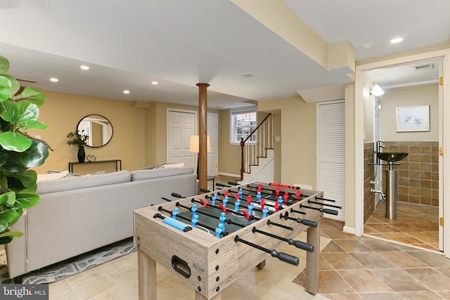 recreation room featuring tile walls and light tile patterned floors