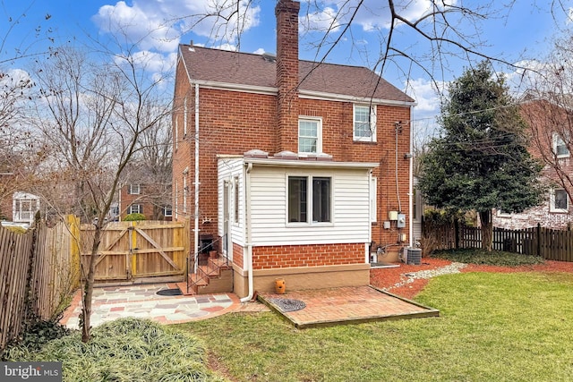 back of property with cooling unit, a yard, and a patio