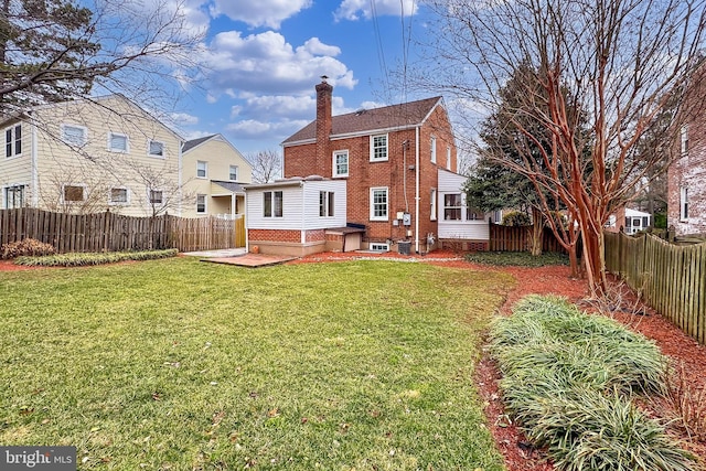 rear view of house with a yard