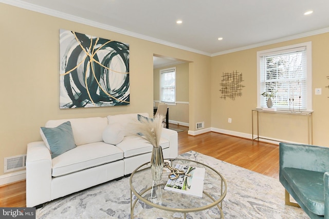 living room with hardwood / wood-style flooring and ornamental molding