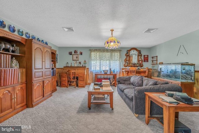 living room featuring light carpet and a textured ceiling