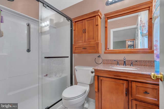 bathroom with vanity, toilet, and an enclosed shower