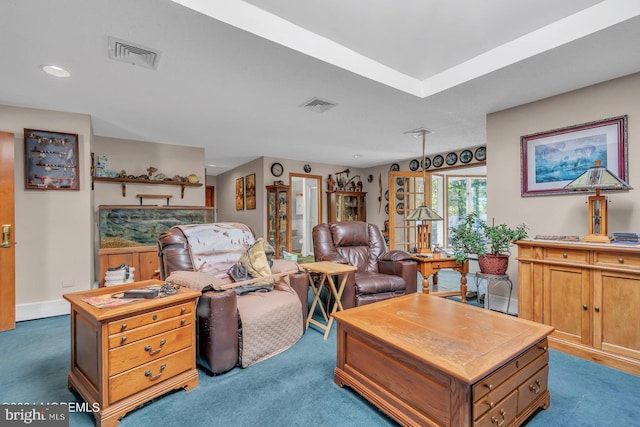 living room with dark colored carpet