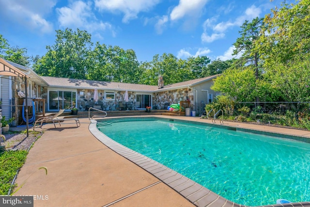 view of swimming pool featuring a patio area