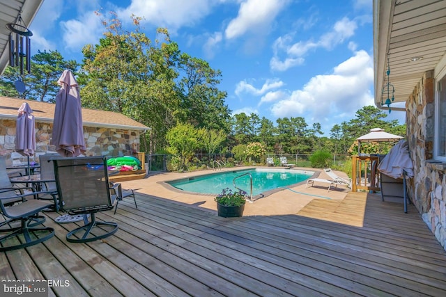 view of swimming pool featuring a wooden deck