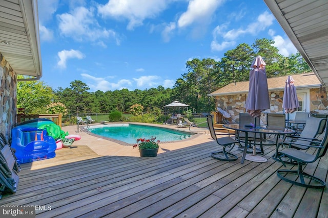 view of pool with a wooden deck