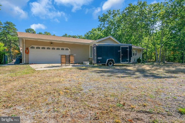 single story home featuring a garage and a front lawn