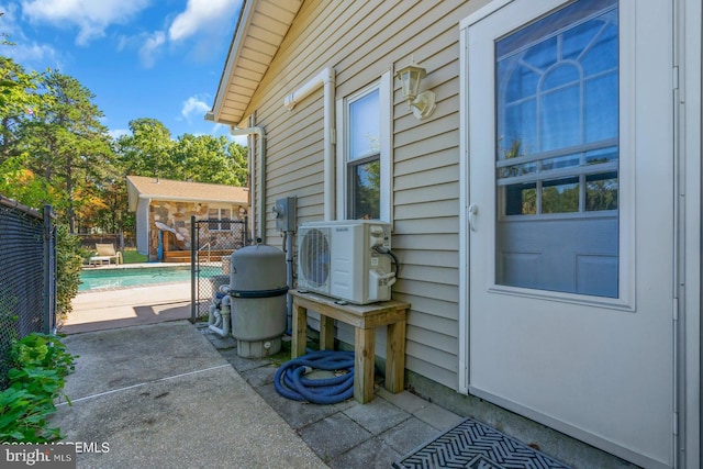 view of patio with ac unit and an outdoor structure