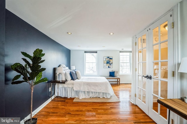 bedroom featuring baseboards, french doors, wood finished floors, and recessed lighting