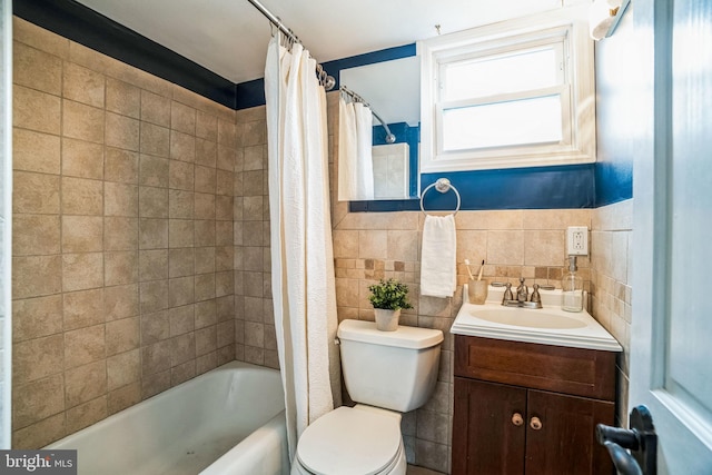 full bathroom with shower / bath combo with shower curtain, vanity, toilet, and tile walls