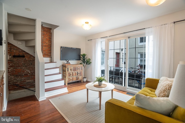 living room with baseboards, stairway, and dark wood-style flooring