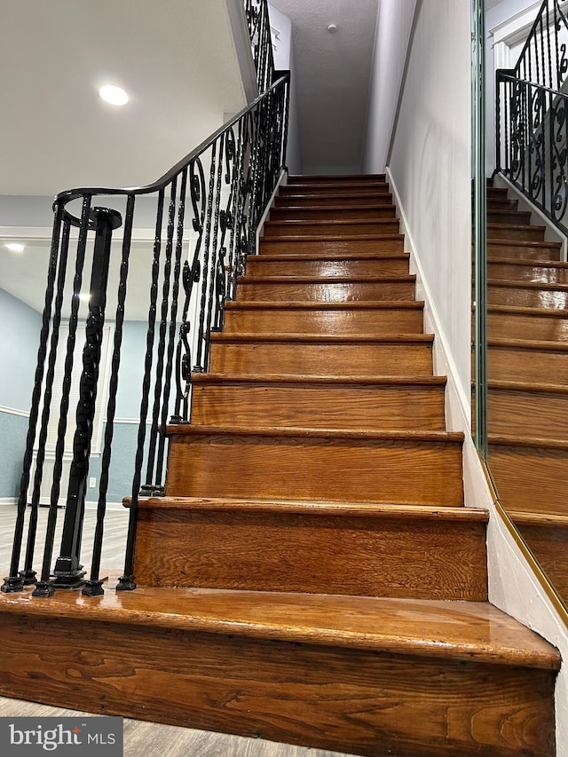 staircase with wood-type flooring