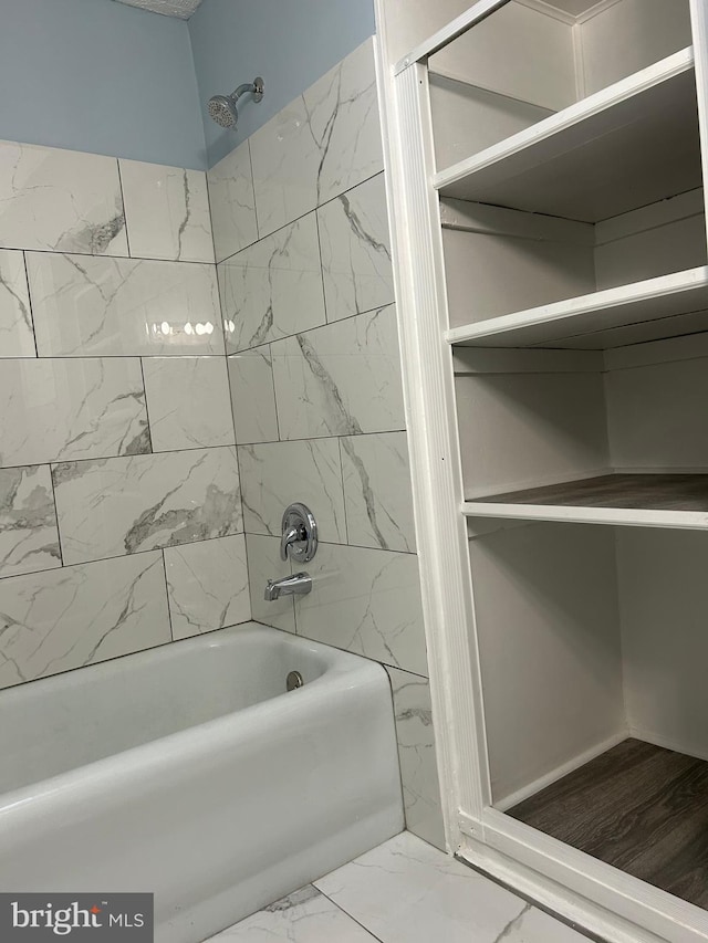 bathroom featuring tiled shower / bath