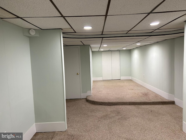 basement with carpet and a drop ceiling