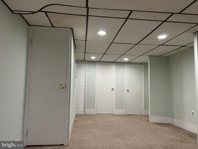 interior space with carpet flooring and a paneled ceiling